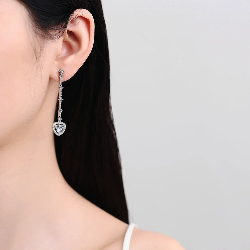 Heart Moissanite Stud Dangle Earrings with CZ in Rhodium-Plated S925 sterling silver worn on ear by model showing scale, placement, and stud dangle earrings styling