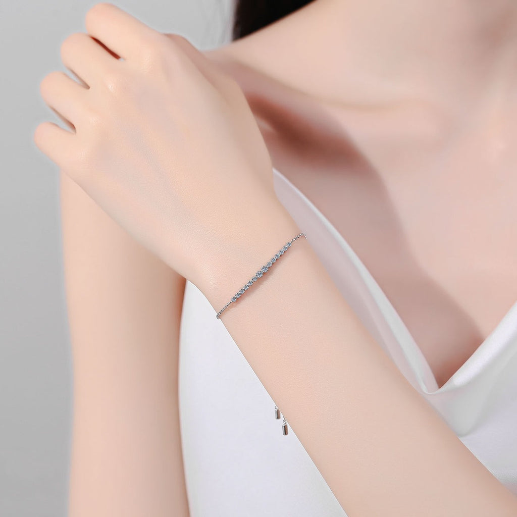 Round Moissanite Tennis Bracelet in Rhodium and Champion Gold-Plated S925 sterling silver worn on wrist model view showing scale and adjustable fit