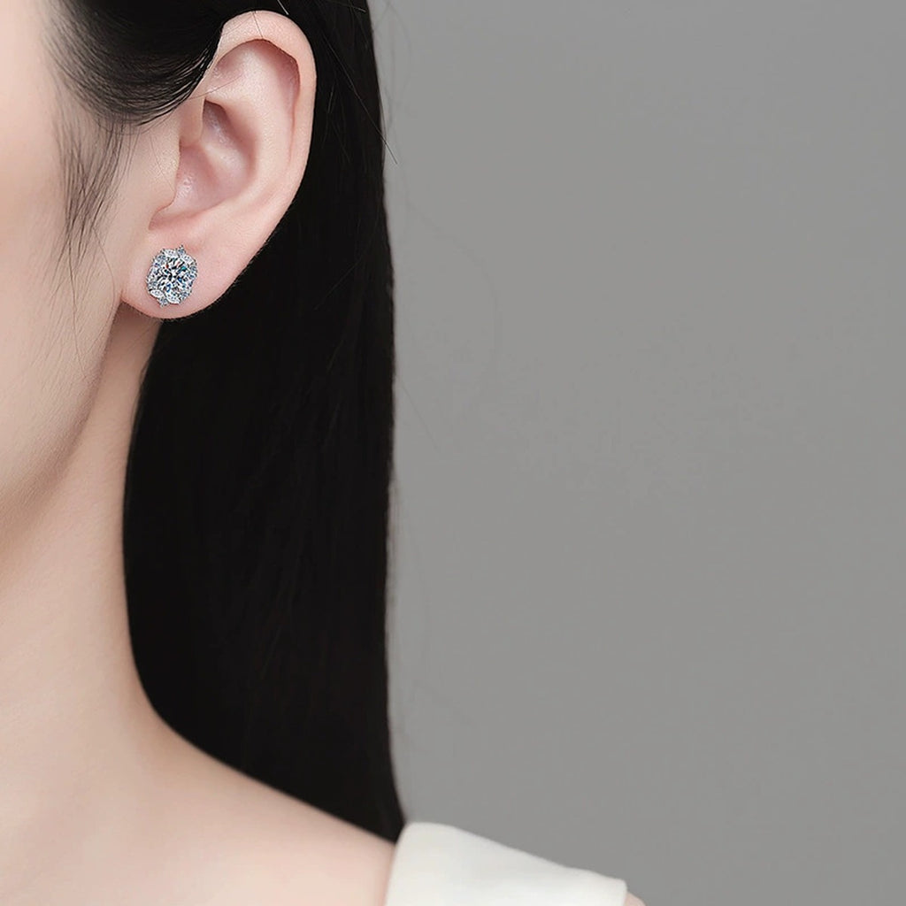 Oval Moissanite Stud Earrings with CZ in Rhodium-Plated S925 sterling silver worn on ear by model showing scale, placement, and stud earrings styling