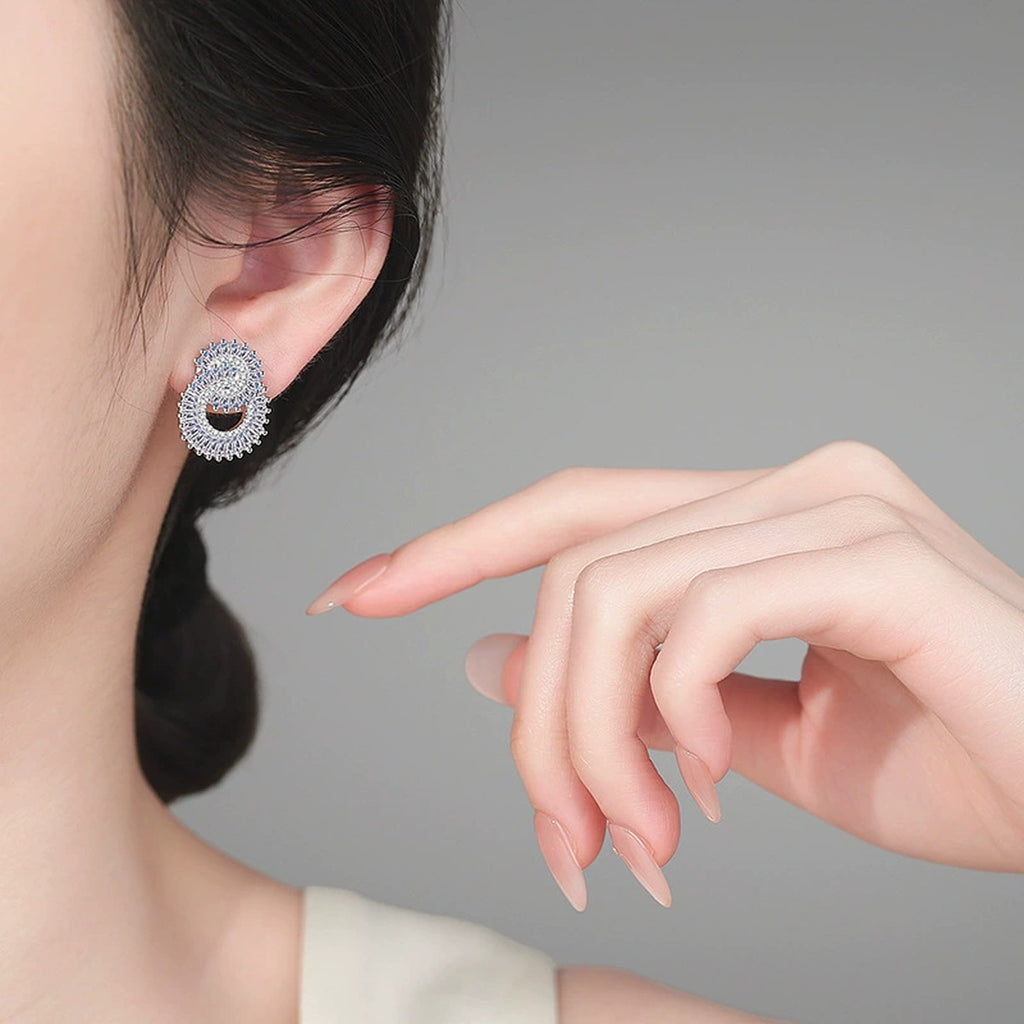 Pear-Shaped Mixed Cut Moissanite Stud Earrings in Rhodium-Plated S925 sterling silver worn on ear by model showing scale, placement, and stud earrings styling
