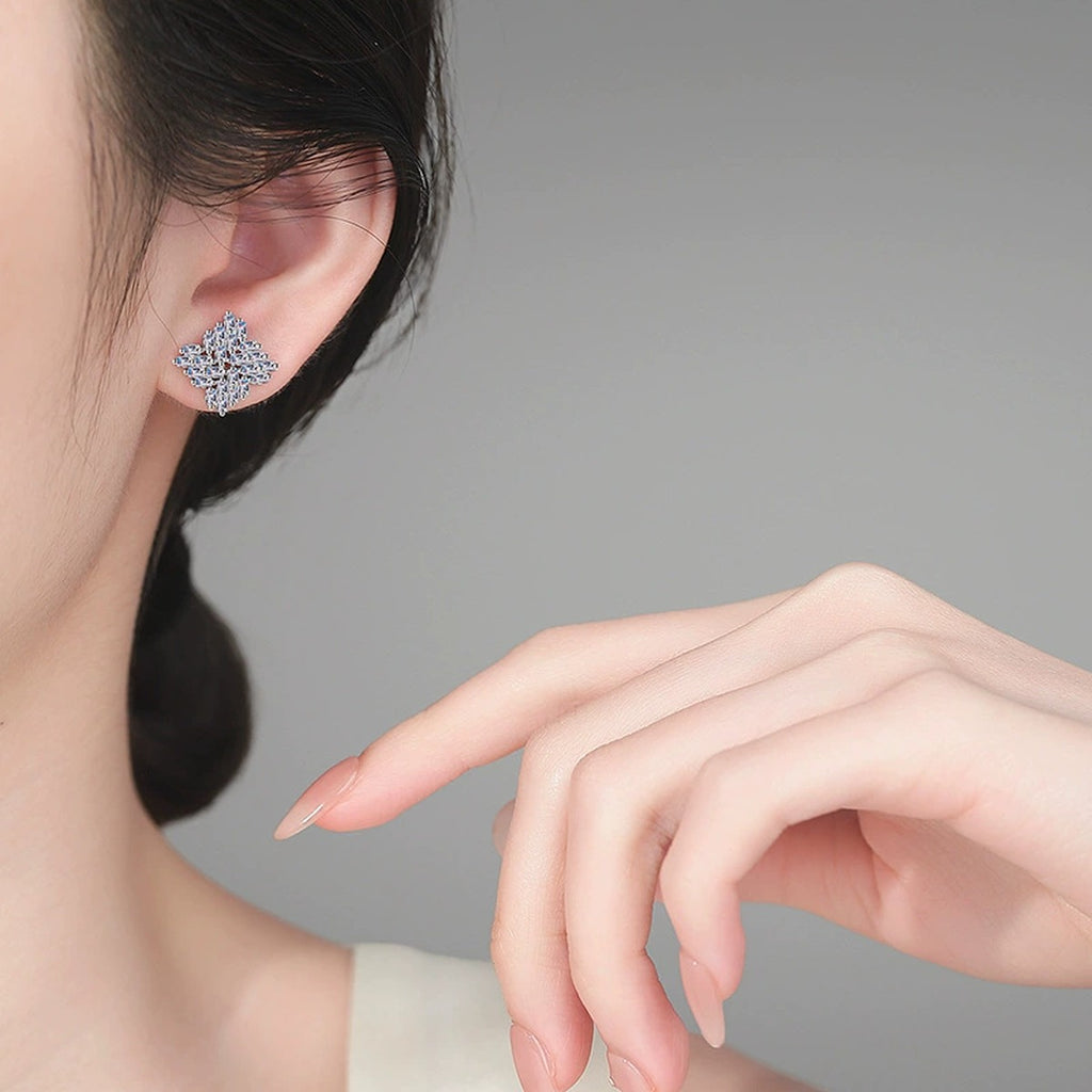 Emerald Cut Moissanite Stud Earrings in Rhodium-Plated S925 sterling silver worn on ear by model showing scale, placement, and stud earrings styling