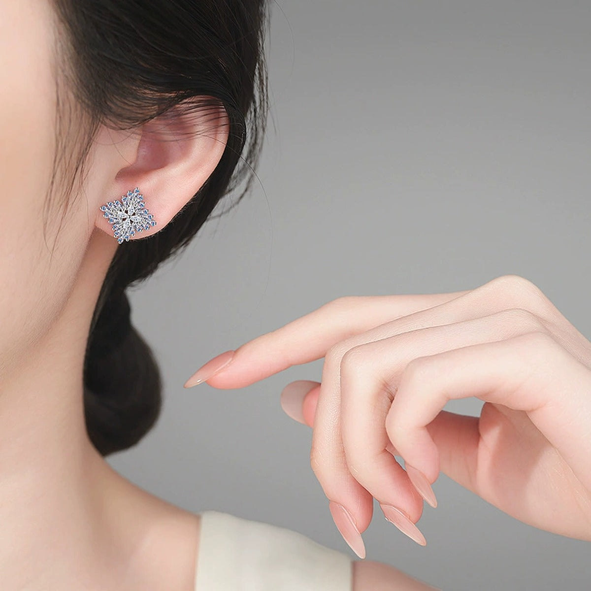 Mixed Cut Moissanite Cluster Stud Earrings in Rhodium-Plated S925 sterling silver worn on ear by model showing scale, placement, and stud earrings styling