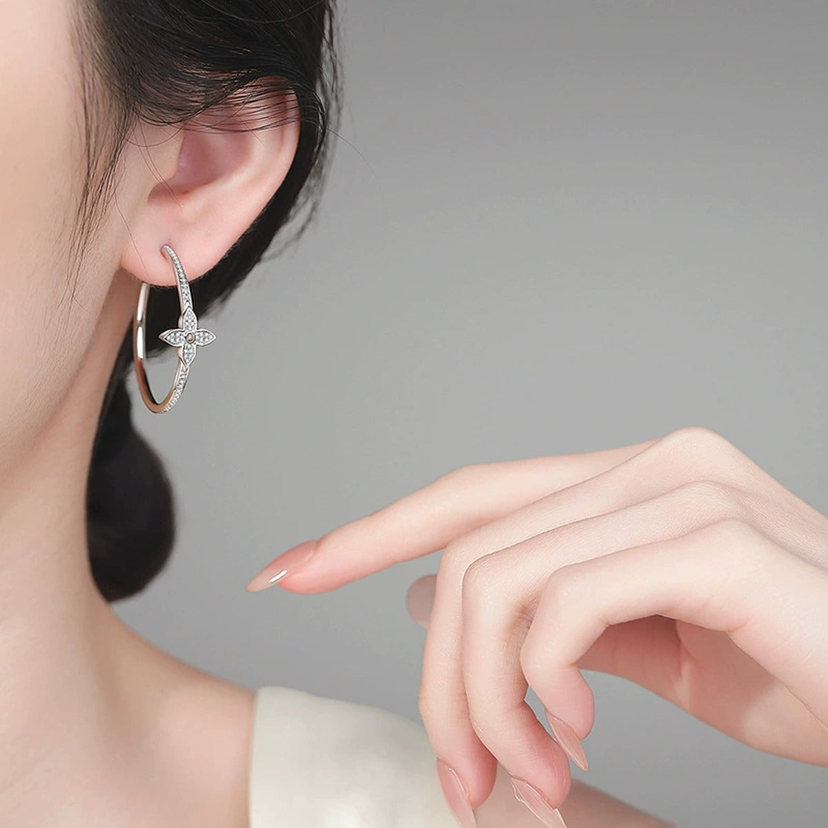 Floral Moissanite Stud Hoop Earrings in Rhodium-Plated S925 sterling silver worn on ear by model showing scale, placement, and stud hoop earrings styling