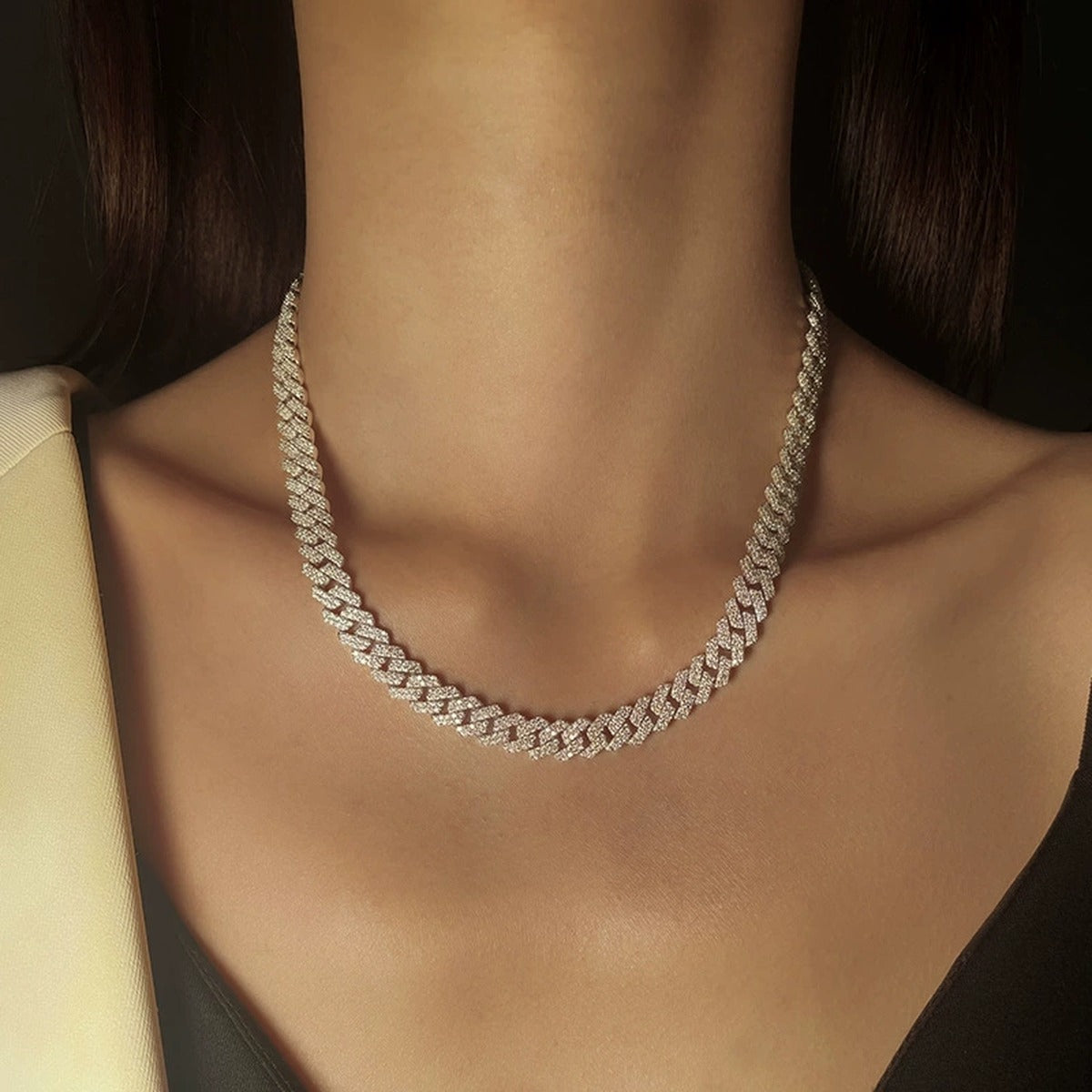 White gold-plated iced Cuban link moissanite necklace worn on model neckline