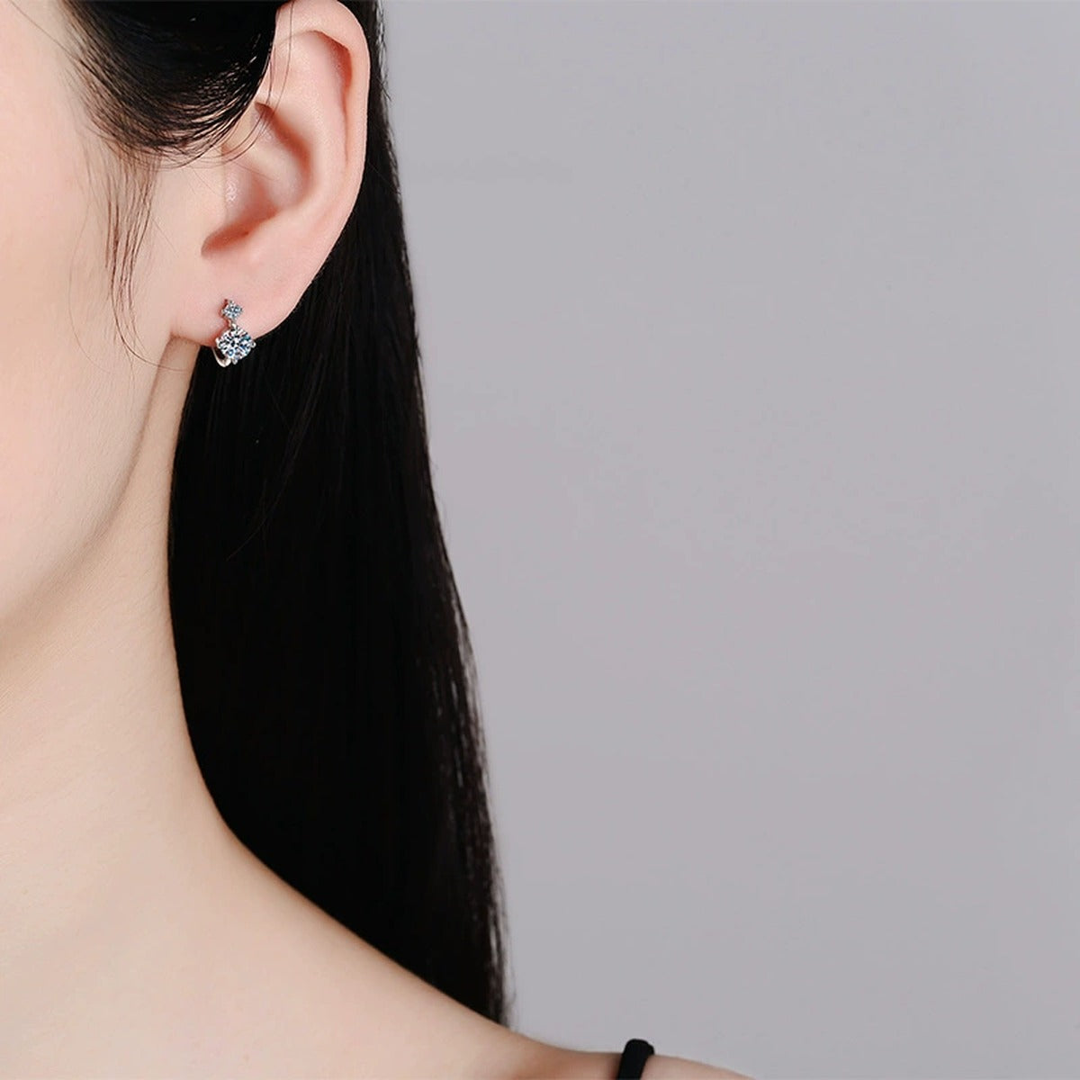 Two-Stone Moissanite Hoop Earrings in White Gold-Plated S925 Silver worn on ear by model