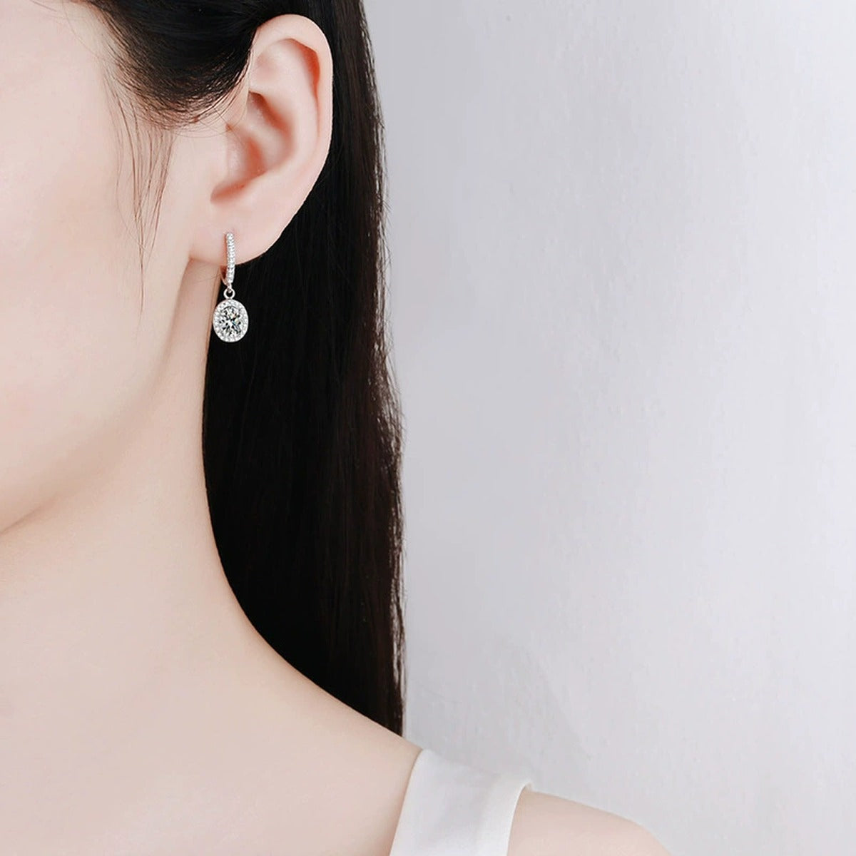 Oval Moissanite Hoop Drop Earrings with CZ in White Gold-Plated S925 worn on ear by model