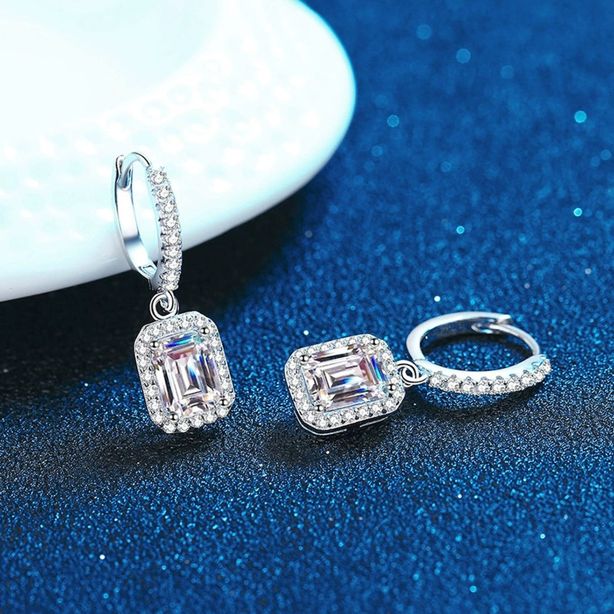 Radiant and Emerald Cut Moissanite Hoop Drop Earrings with CZ in S925 blue scene angled view