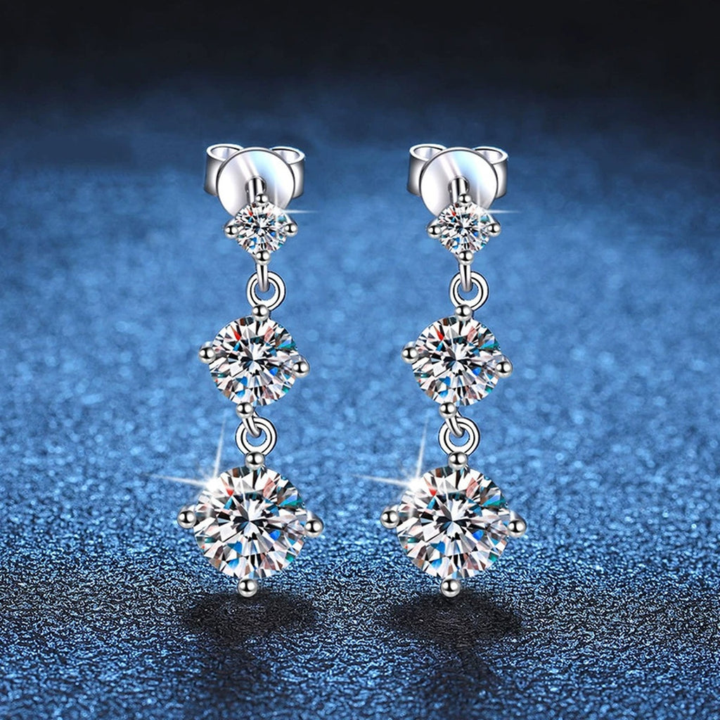 Graduated Moissanite Drop Earrings in White Gold-Plated S925 Sterling Silver blue scene angled view