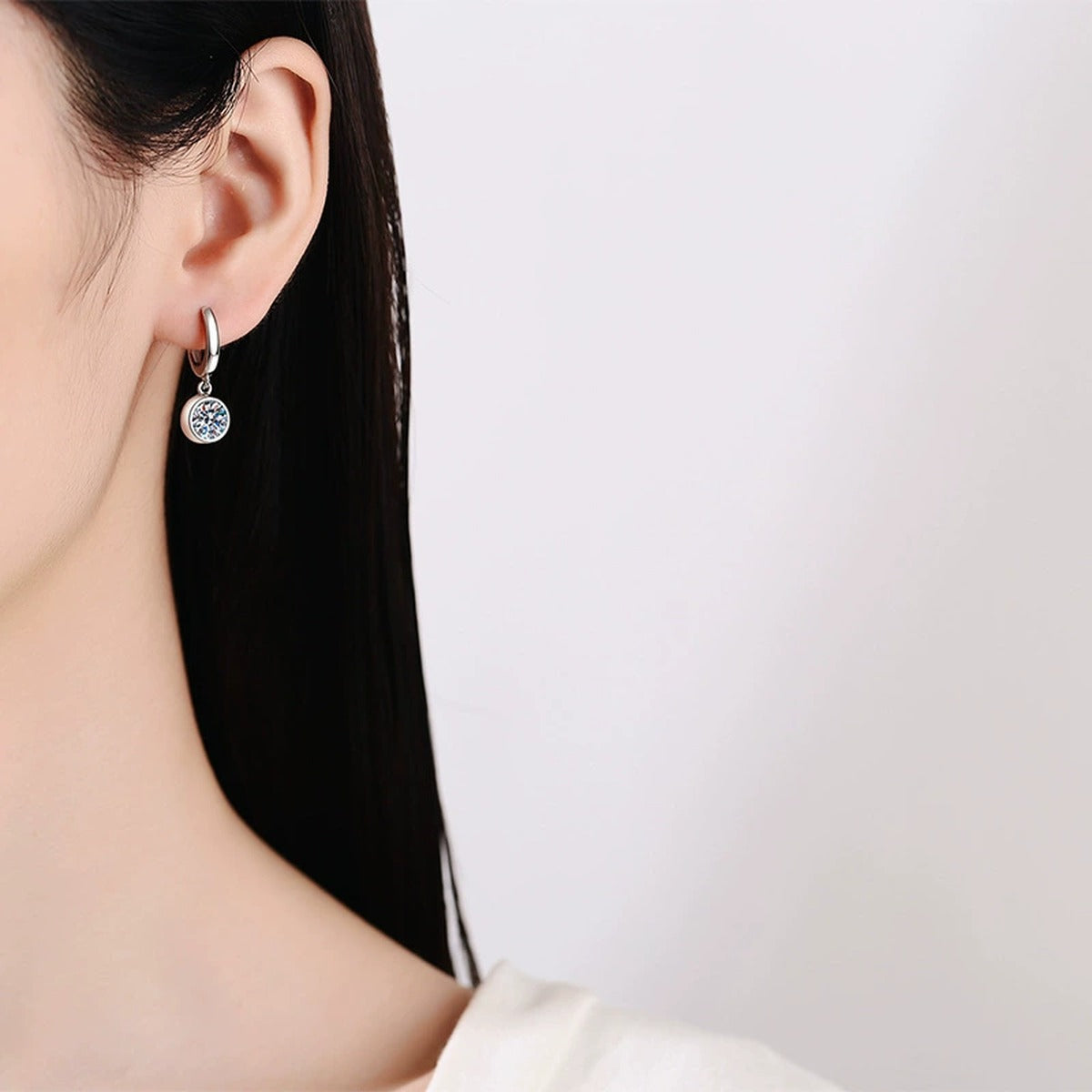 Round Moissanite Hoop Earrings in White Gold-Plated S925 Sterling Silver worn on ear by model