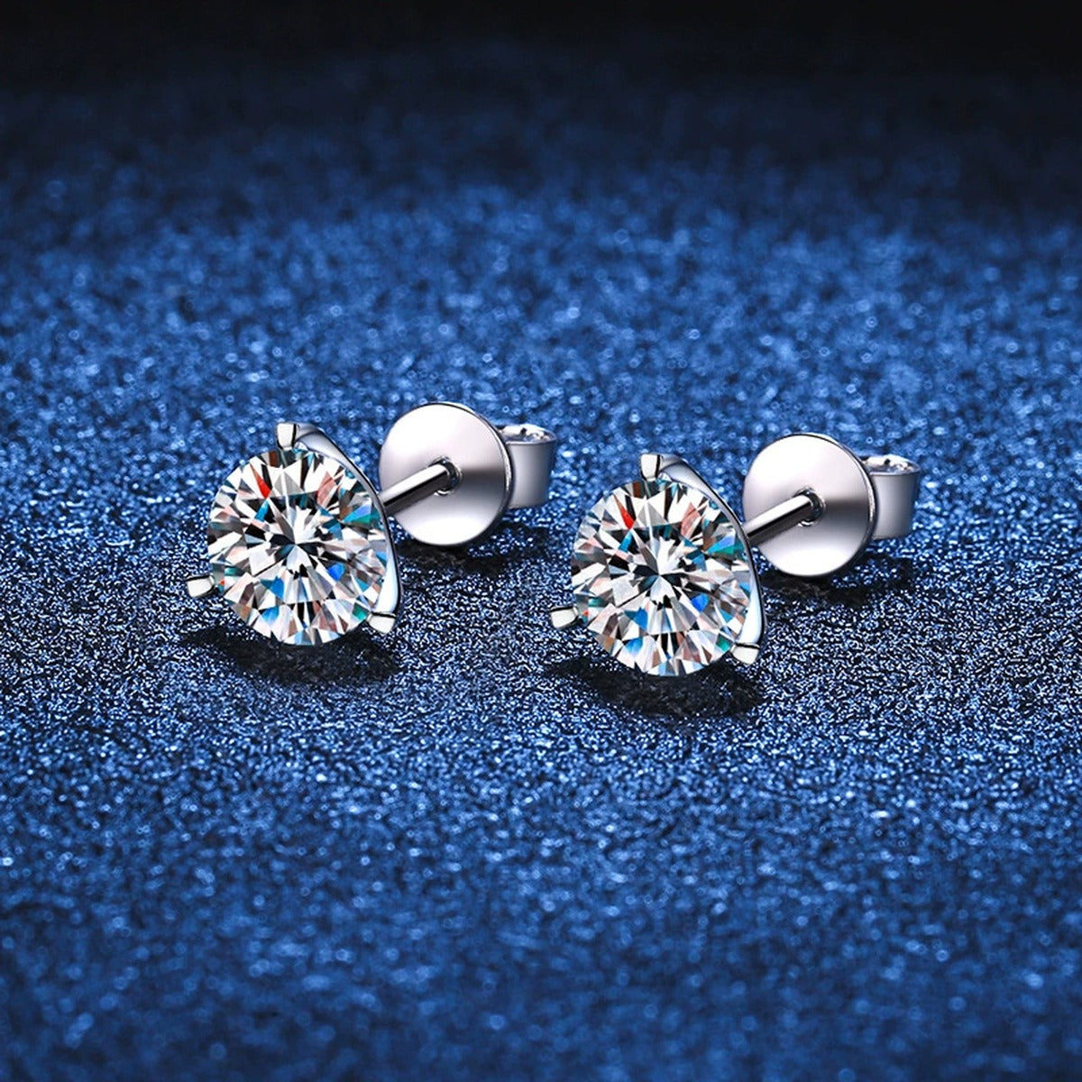 Round Moissanite Stud Earrings in White Gold-Plated S925 Sterling Silver blue scene angled view