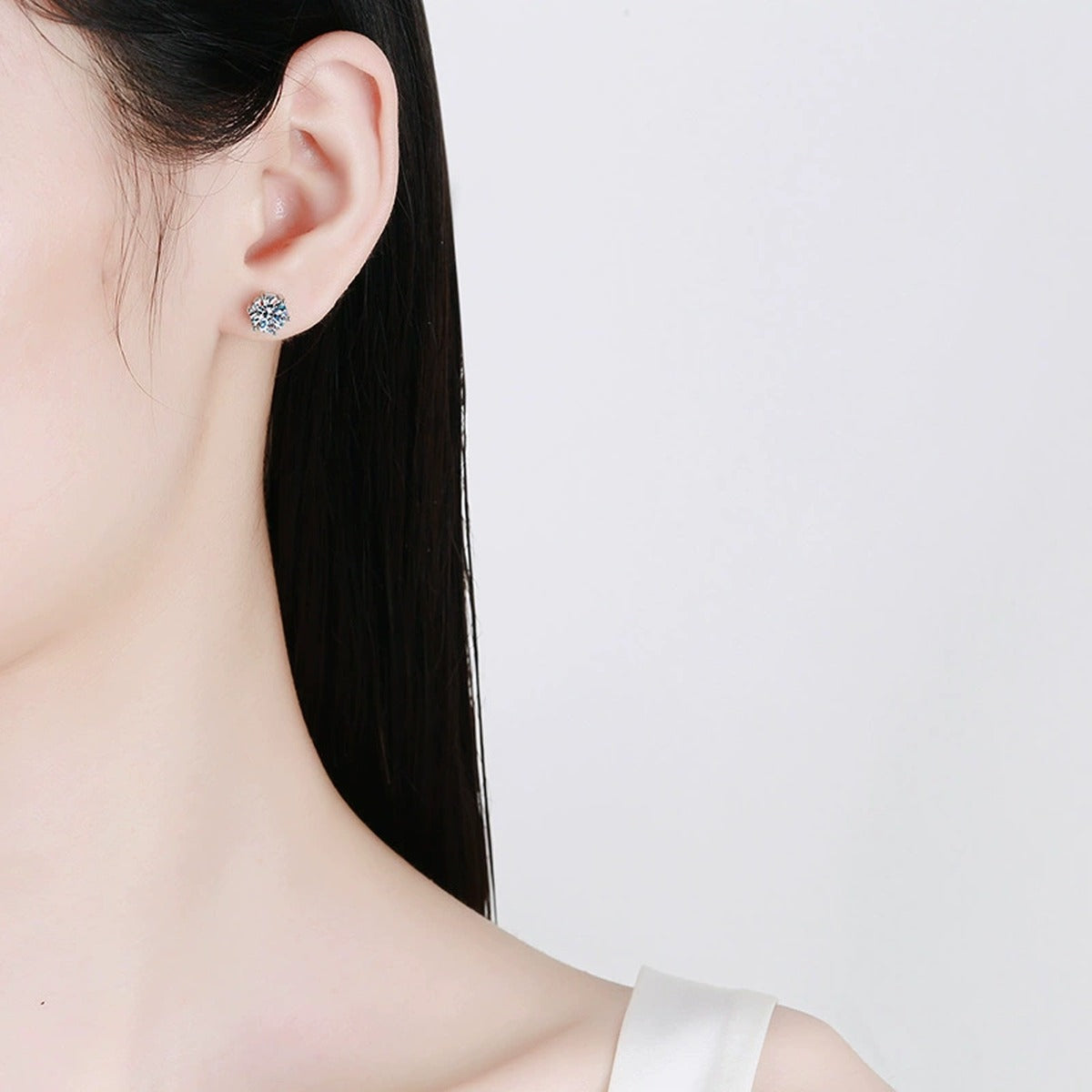 Round Moissanite Stud Earrings in White Gold-Plated S925 Sterling Silver worn on ear by model