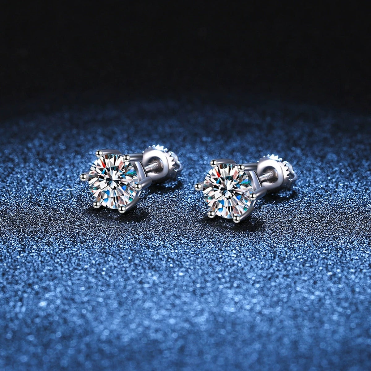 Round Moissanite Stud Earrings in White Gold-Plated S925 Sterling Silver blue scene angled view