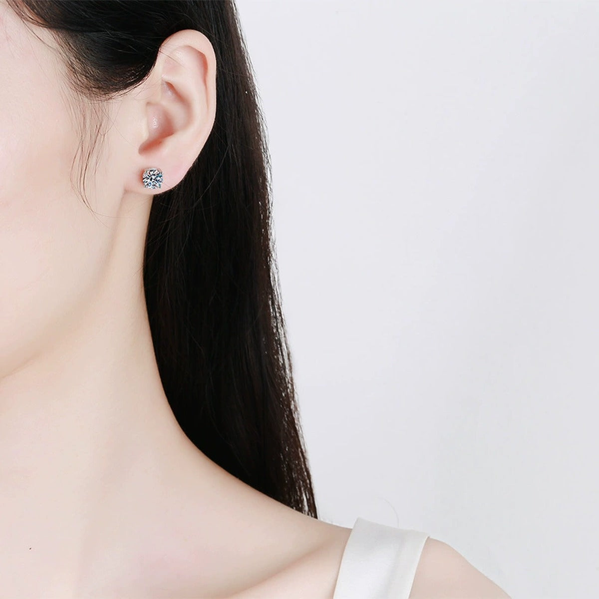Round Moissanite Stud Earrings in White Gold-Plated S925 Sterling Silver worn on ear by model