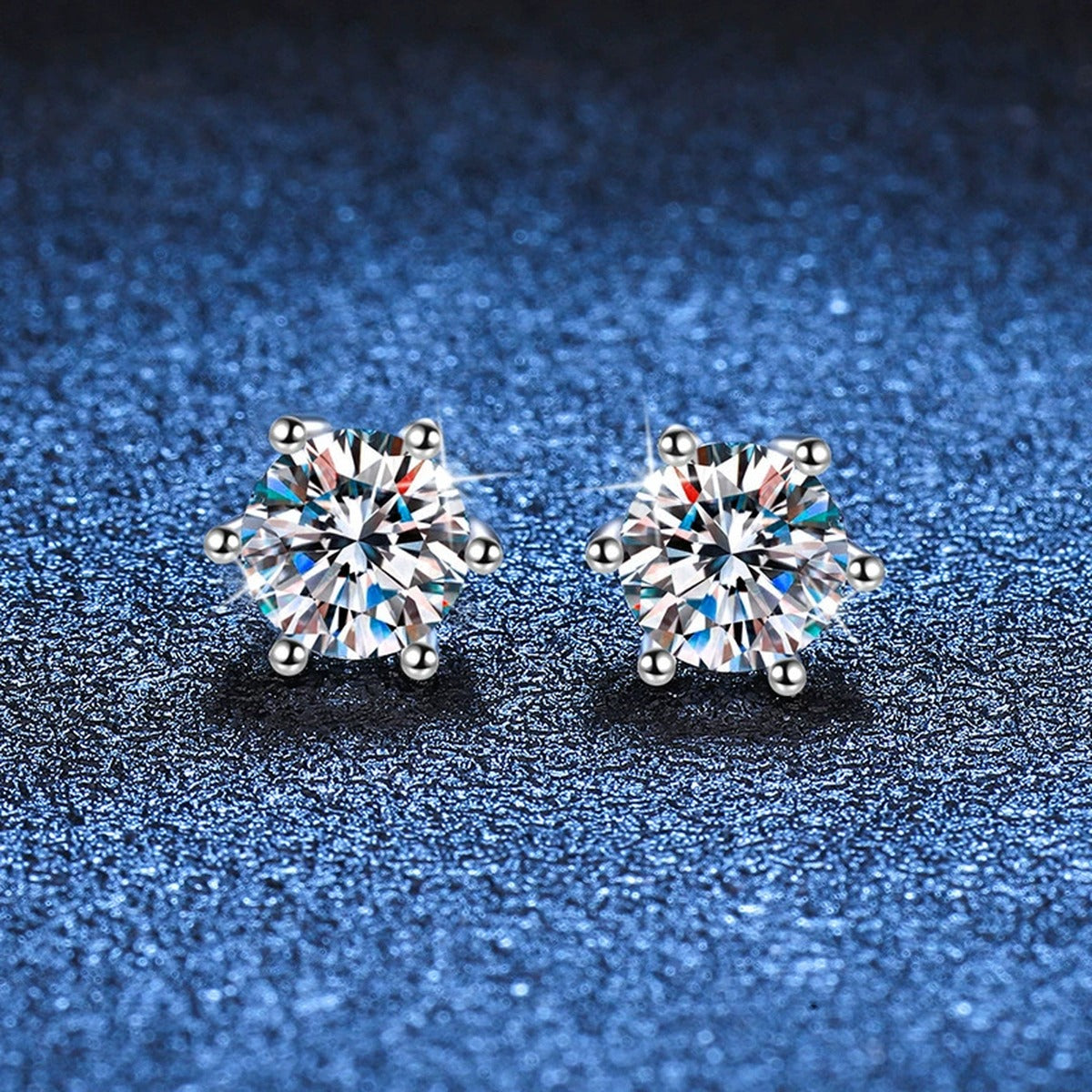 Round Moissanite Stud Earrings in White Gold-Plated S925 Sterling Silver blue scene close-up view