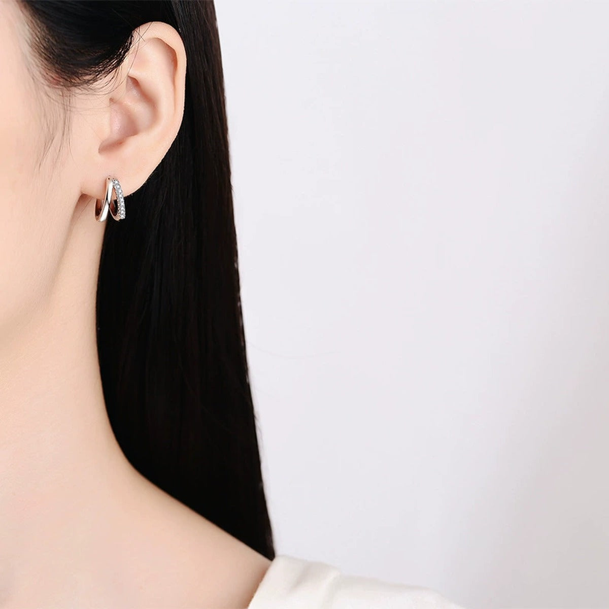 Pavé Moissanite Hoop Earrings in White Gold-Plated S925 Sterling Silver worn on ear by model