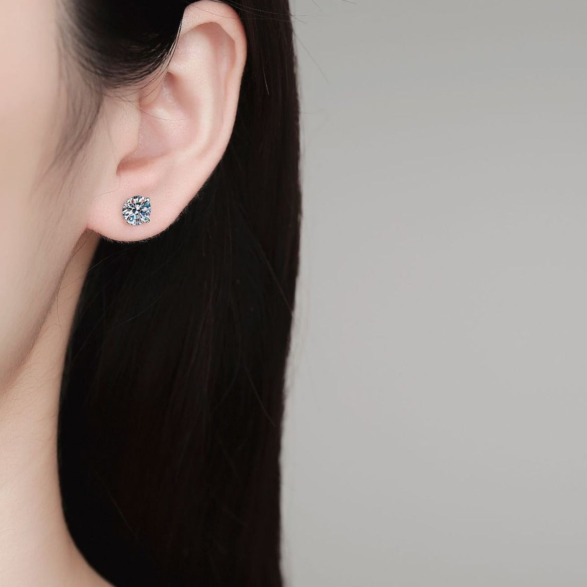 Round Moissanite Stud Earrings in White Gold-Plated S925 Sterling Silver worn on ear by model