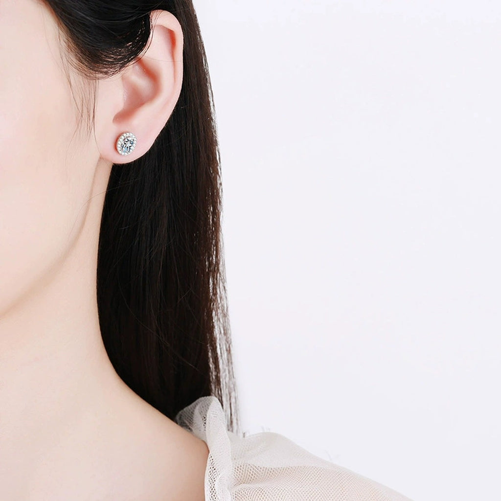 Oval Halo Moissanite Stud Earrings with CZ in White Gold-Plated S925 worn on ear by model
