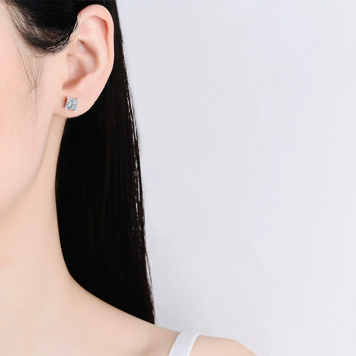 Princess Cut Moissanite Stud Earrings in White Gold-Plated S925 Silver worn on ear by model