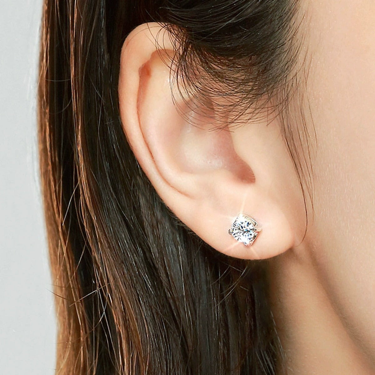 Princess Cut Moissanite Stud Earrings in White Gold-Plated S925 Silver worn on ear by model