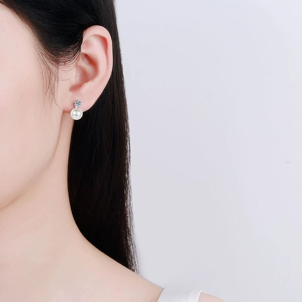 Pearl Moissanite Stud Earrings in White Gold-Plated S925 Sterling Silver worn on ear by model