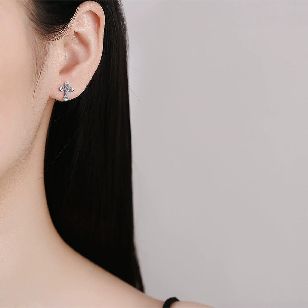 Cross Moissanite Stud Earrings with CZ in White Gold-Plated S925 worn on ear by model