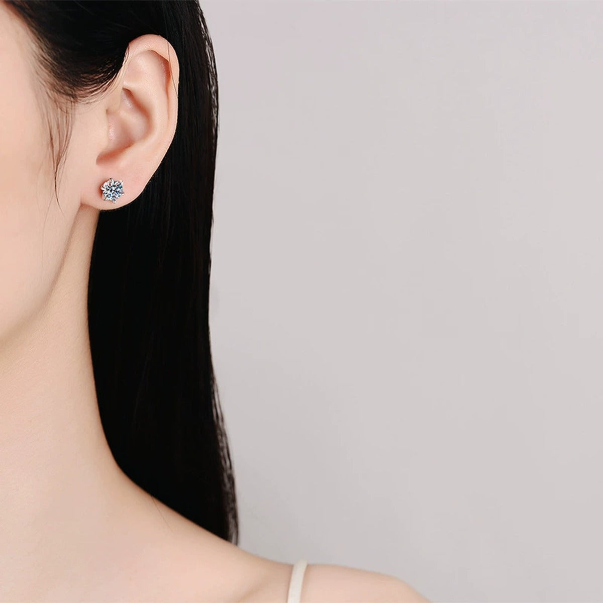Floral Moissanite Stud Earrings in White Gold-Plated S925 Sterling Silver worn on ear by model