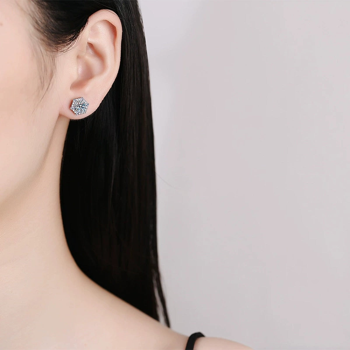 Hexagon Halo Moissanite Stud Earrings with CZ in White Gold-Plated S925 worn on ear by model