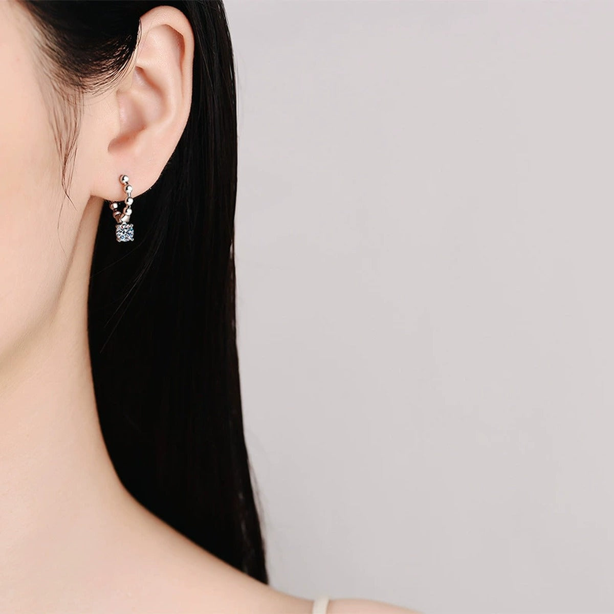 Beaded Hoop Moissanite Drop Earrings in White Gold-Plated S925 Silver worn on ear by model