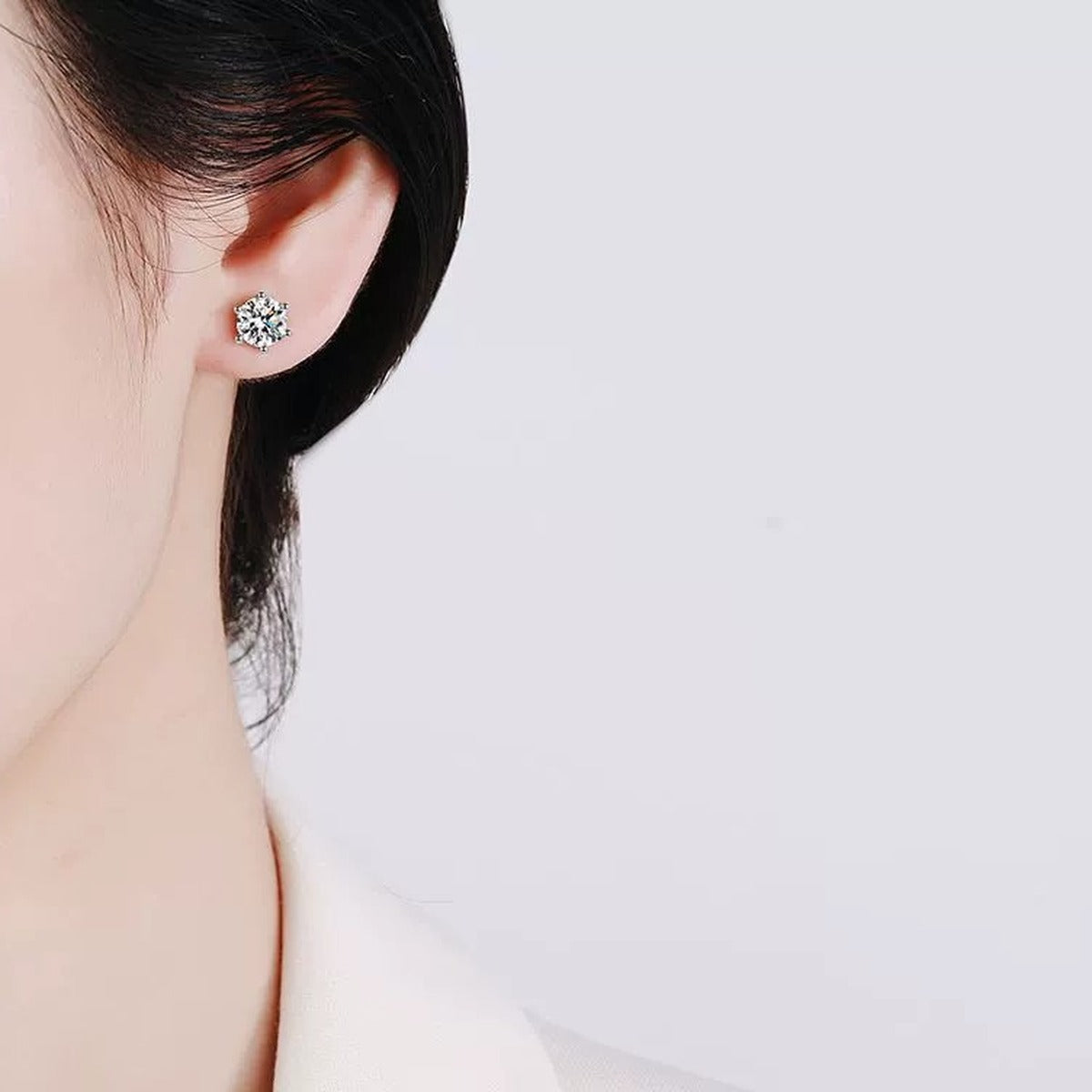 Round Moissanite Stud Earrings in White Gold-Plated S925 Sterling Silver worn on ear by model