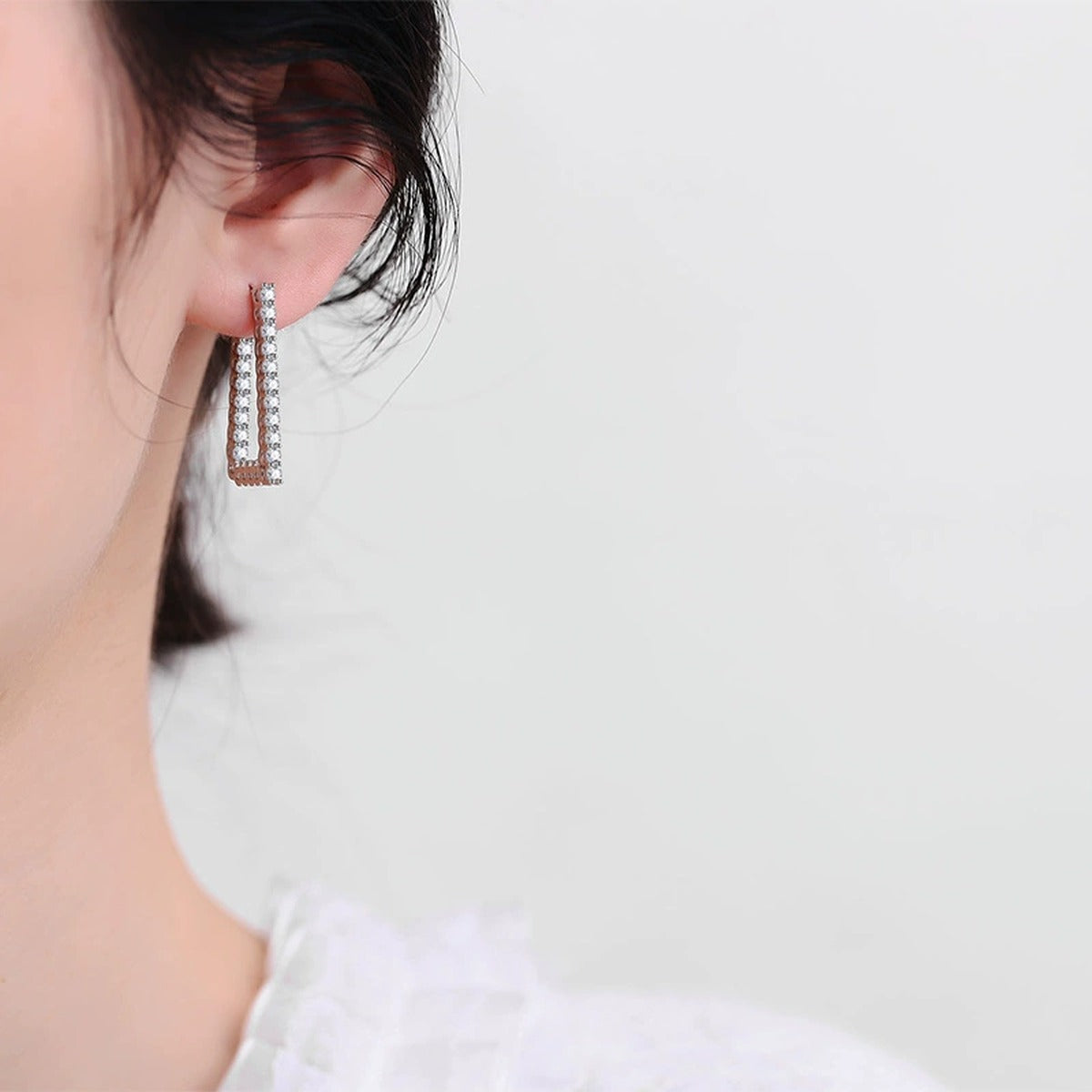 Pave Moissanite Hoop Earrings in White Gold-Plated S925 Sterling Silver worn on ear by model