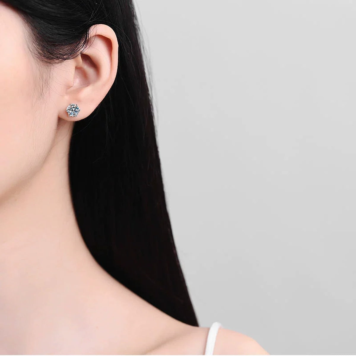 Snowflake Moissanite Stud Earrings in White Gold-Plated S925 Silver worn on ear by model