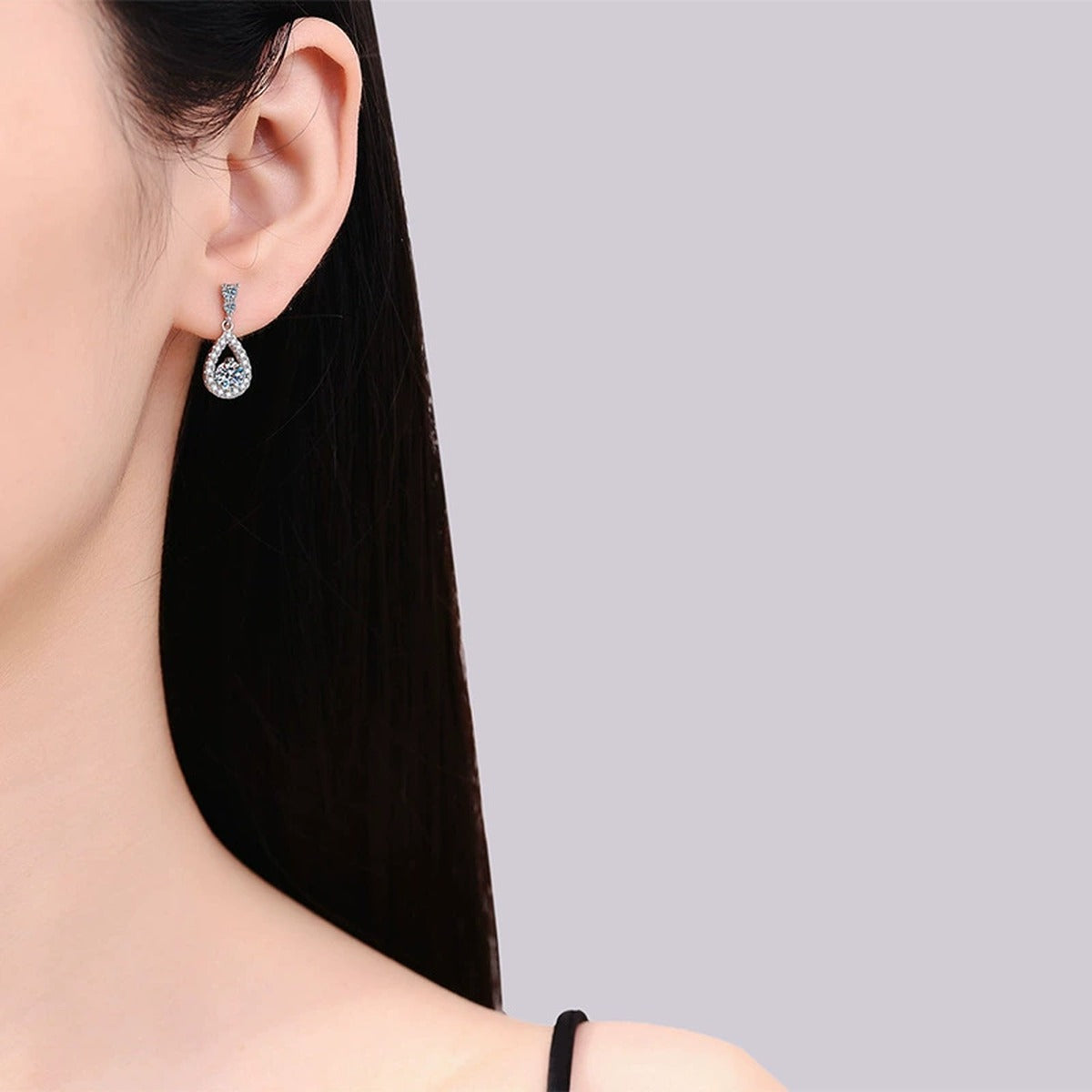 Pear Moissanite Drop Earrings with CZ in White Gold-Plated S925 Silver worn on ear by model