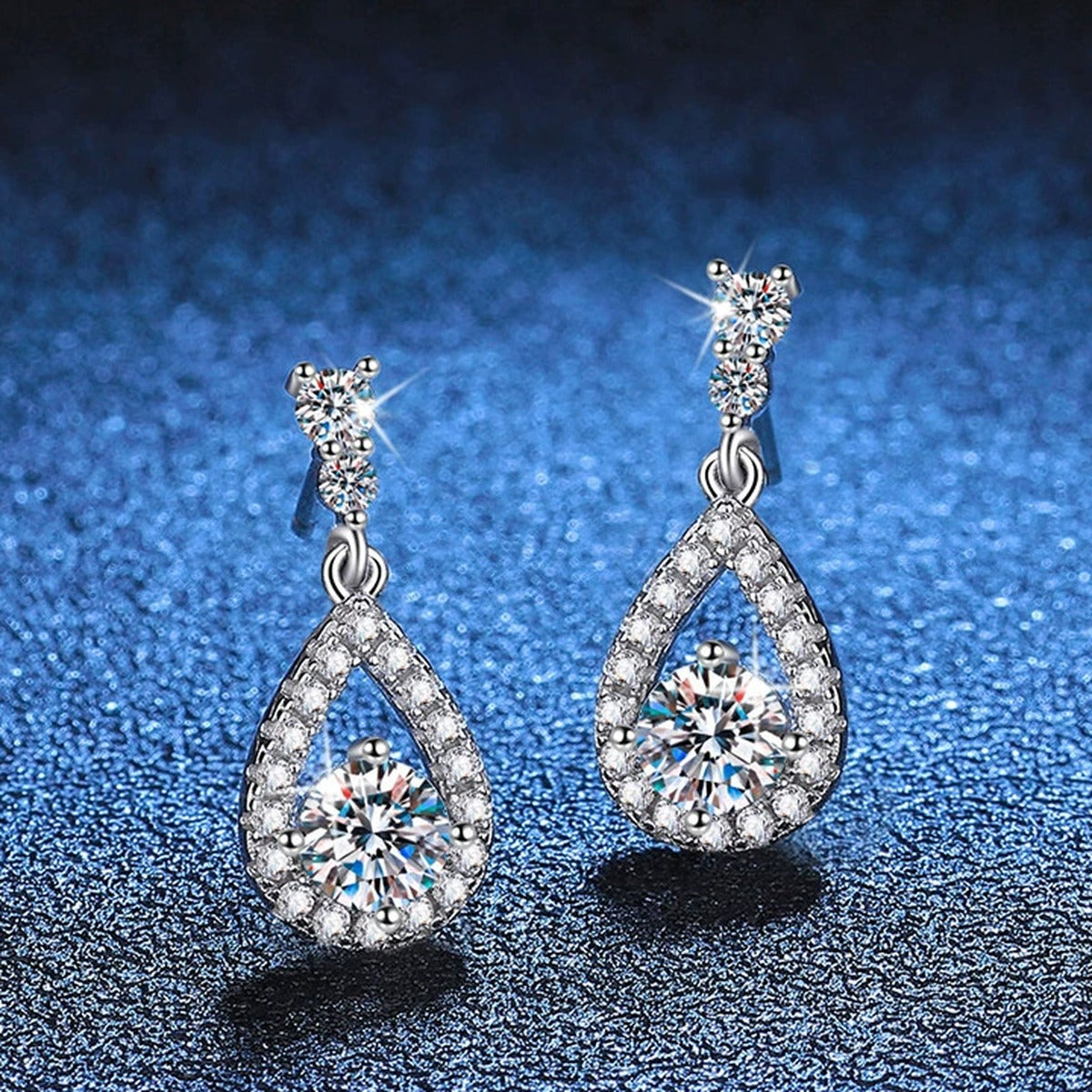 Pear Moissanite Drop Earrings with CZ in White Gold-Plated S925 Silver blue scene close-up view