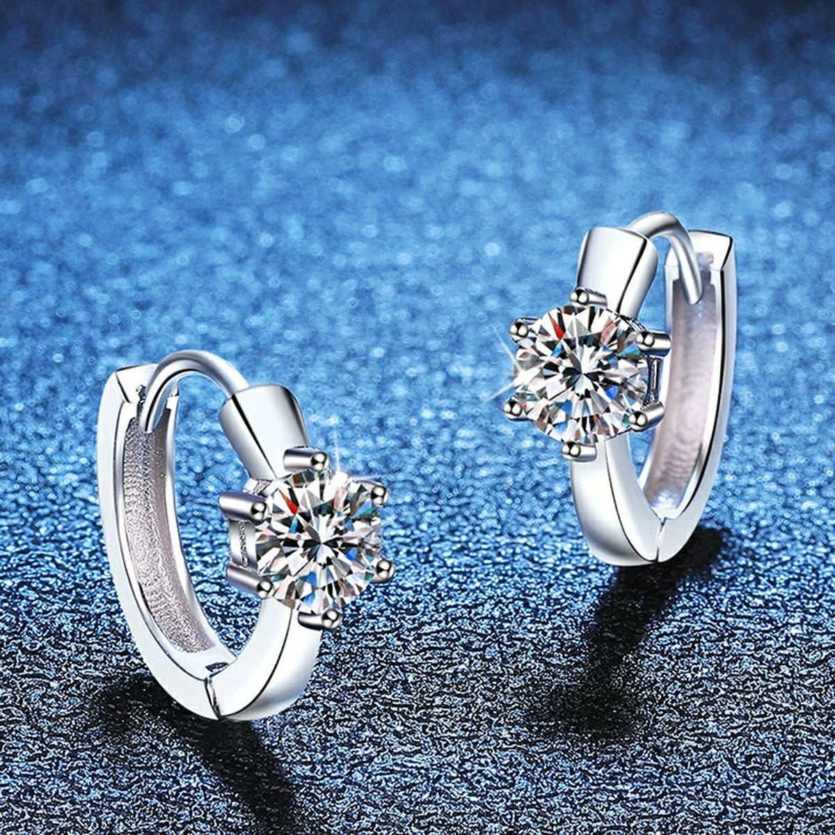 Round Moissanite Huggie Earrings in White Gold-Plated S925 Silver blue scene angled view