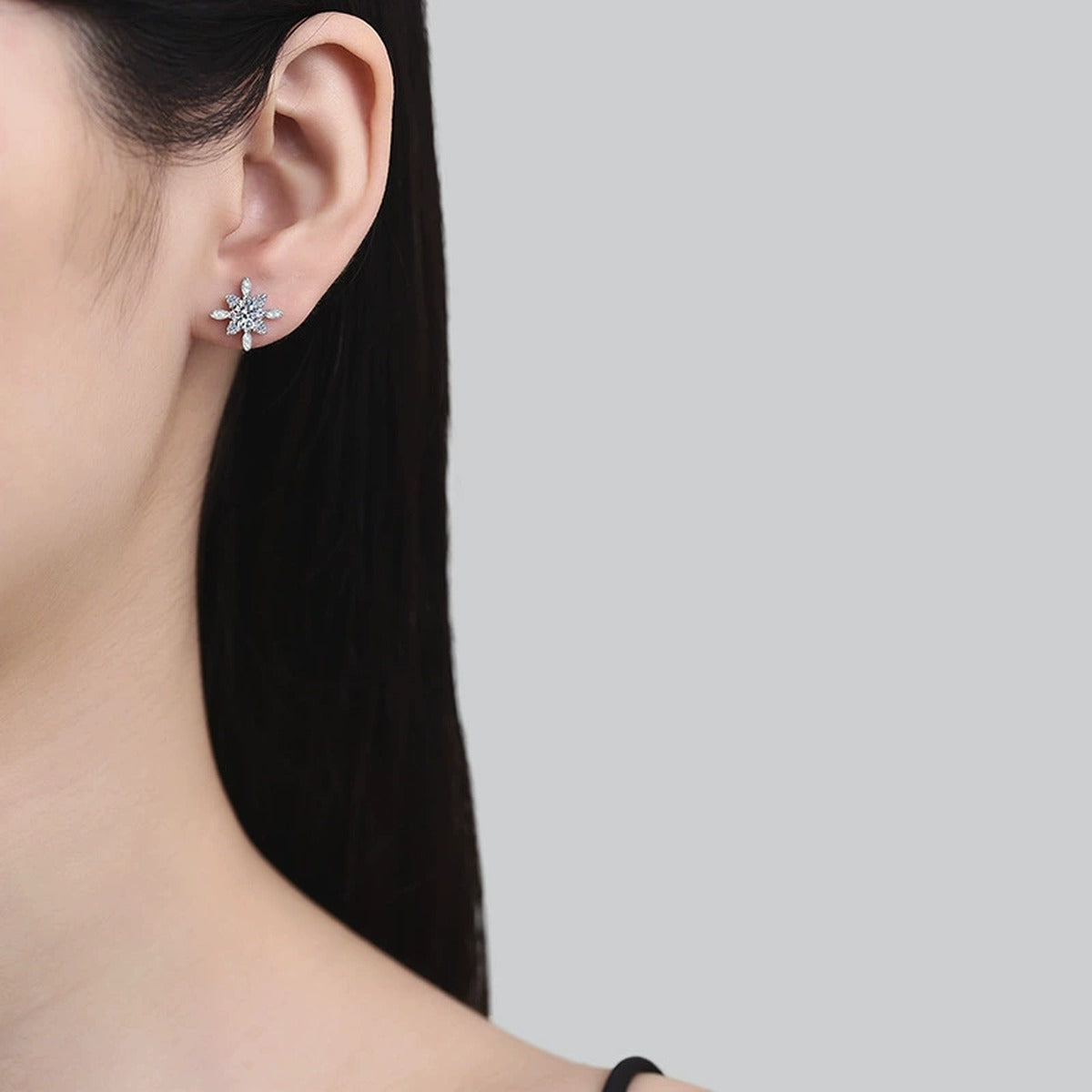 Floral Starburst Moissanite Stud Earrings with CZ in White Gold-Plated S925 worn on ear by model