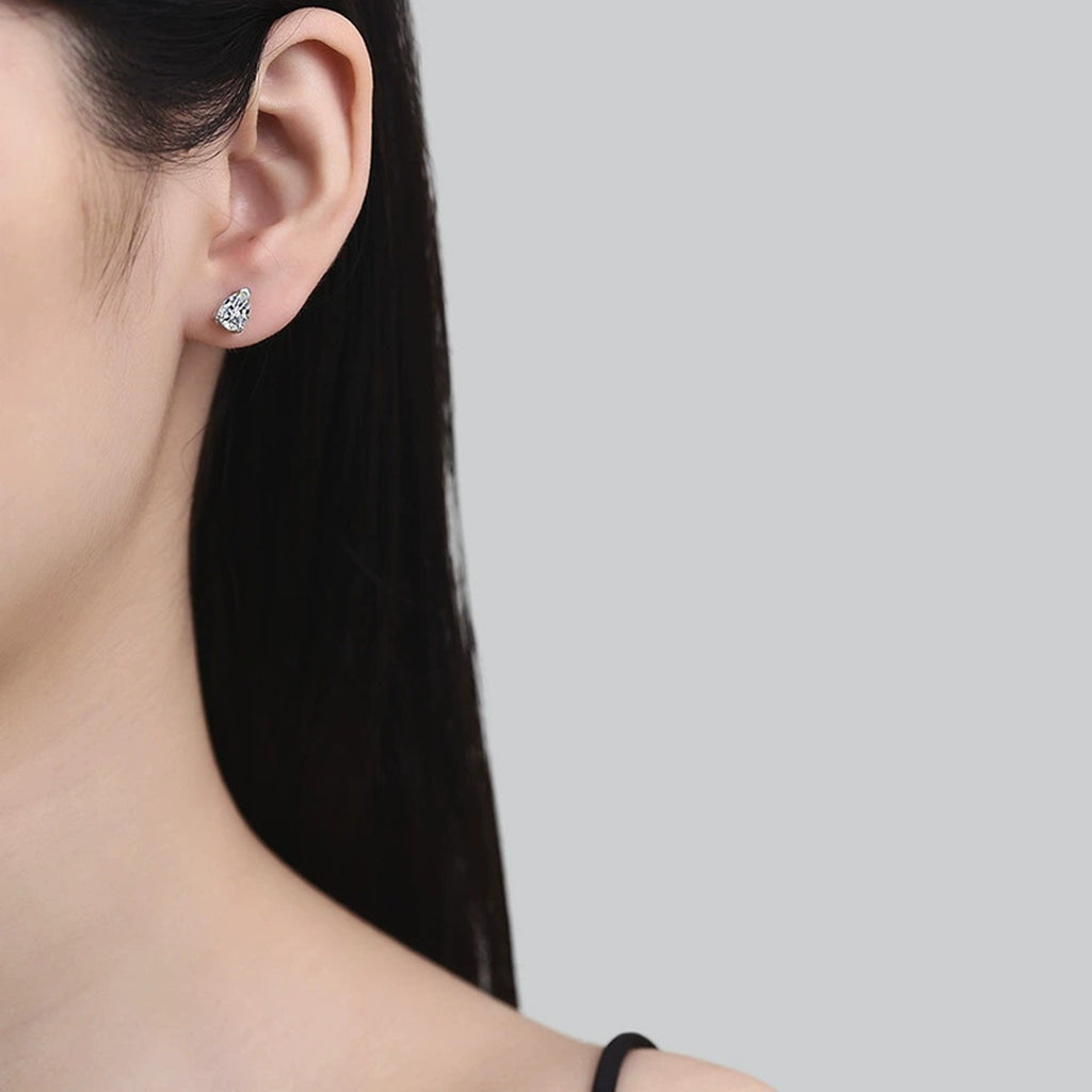 Pear Moissanite Stud Earrings in White Gold-Plated S925 Sterling Silver worn on ear by model