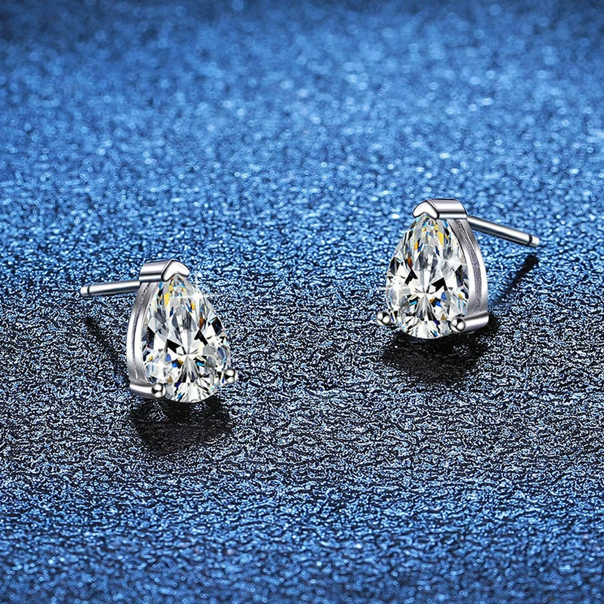 Pear Moissanite Stud Earrings in White Gold-Plated S925 Sterling Silver blue scene angled view