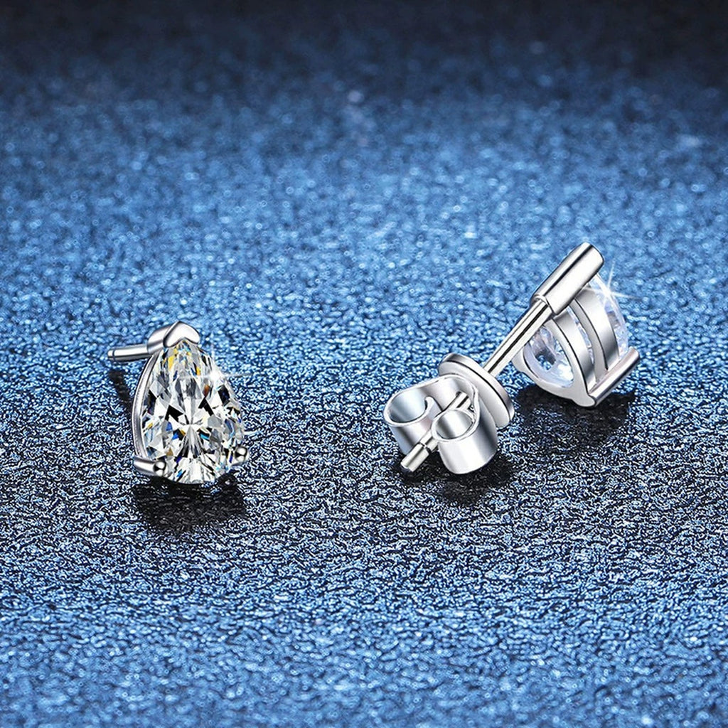 Pear Moissanite Stud Earrings in White Gold-Plated S925 Sterling Silver blue scene close-up view