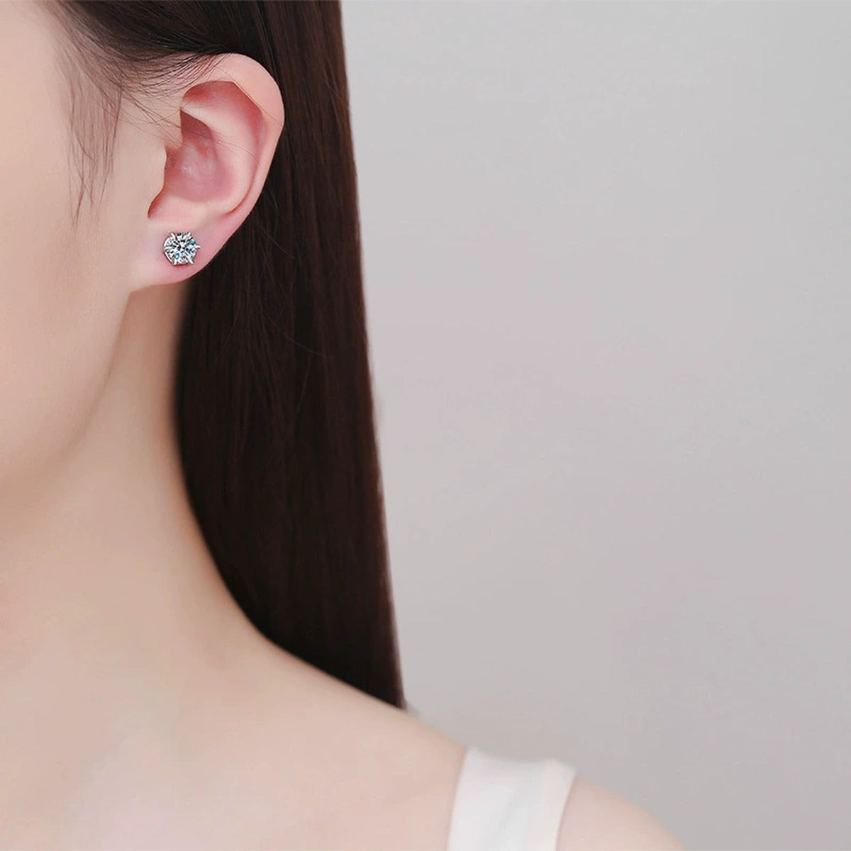 Round Moissanite Huggie Earrings in White Gold-Plated S925 Silver worn on ear by model