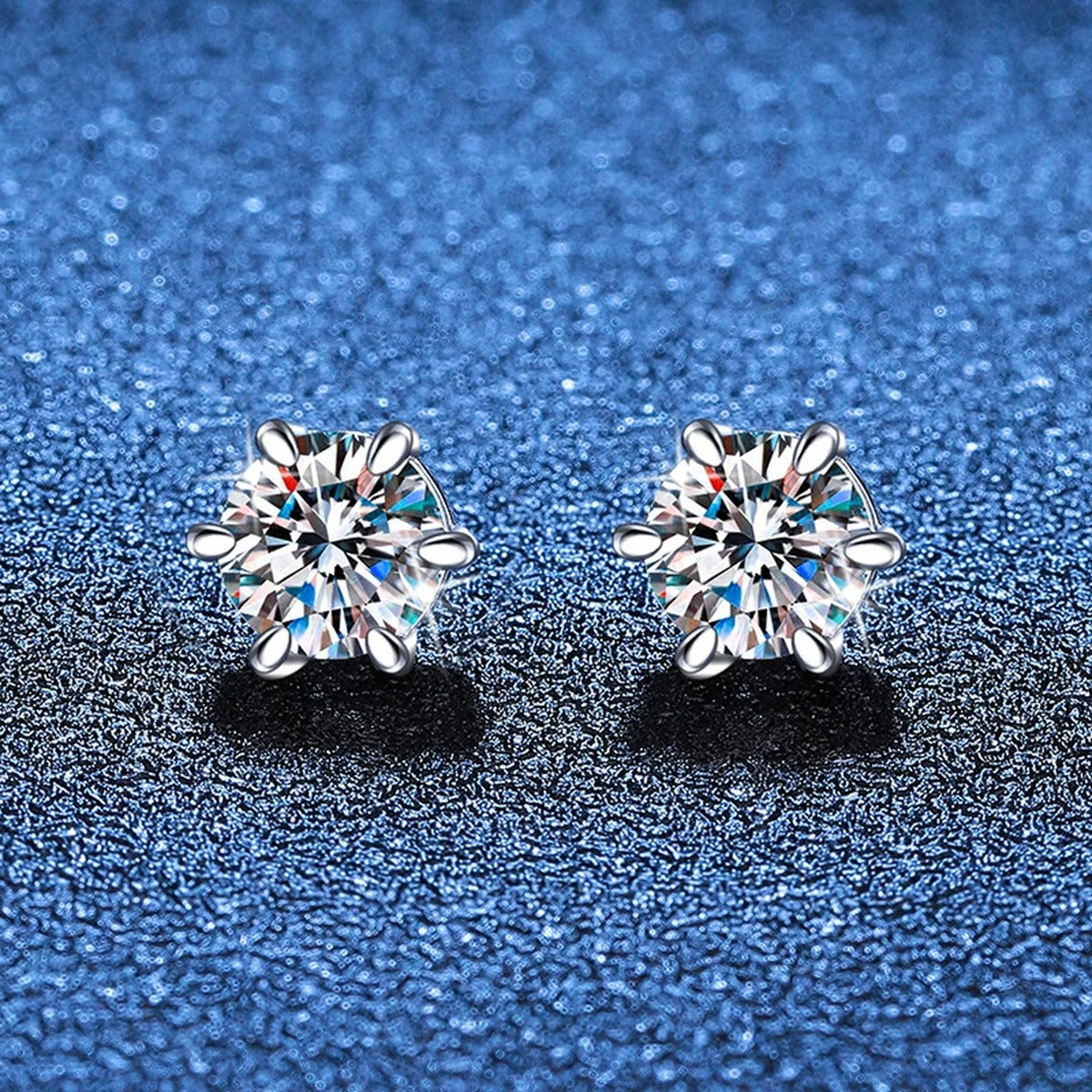 Round Moissanite Huggie Earrings in White Gold-Plated S925 Silver blue scene close-up view