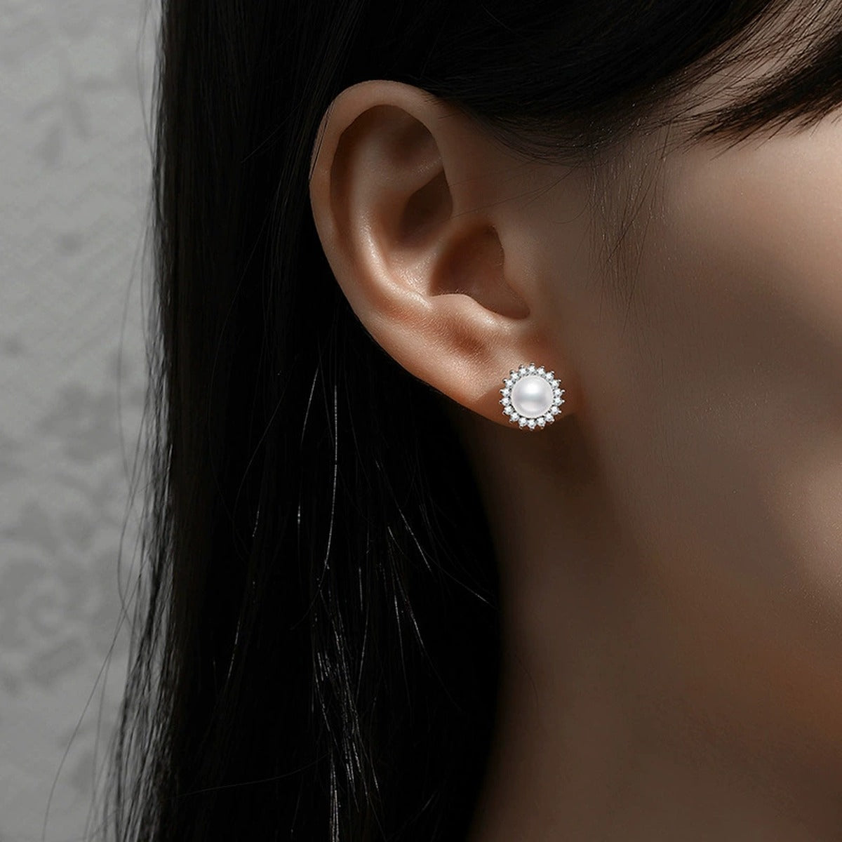 Halo Pearl Stud Earrings with CZ in White Gold-Plated S925 Sterling Silver worn on ear by model