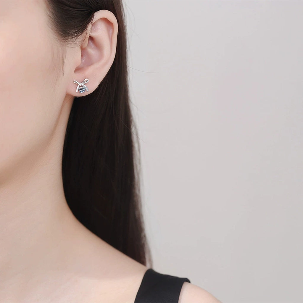Butterfly Moissanite Stud Earrings with CZ in White Gold-Plated S925 worn on ear by model