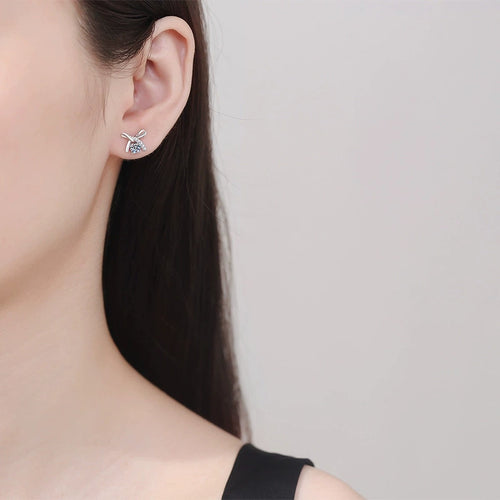 Butterfly Moissanite Stud Earrings with CZ in White Gold-Plated S925 worn on ear by model