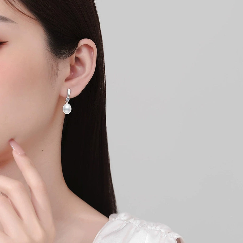 Slender Pearl Moissanite Hook Drop Earrings in White Gold-Plated S925 Sterling Silver worn on ear by model