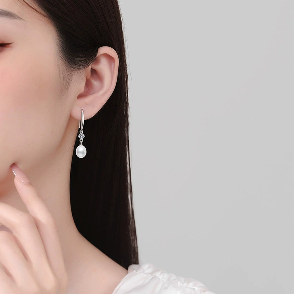 Long Pearl Moissanite Hook Drop Earrings in White Gold-Plated S925 Sterling Silver worn on ear by model