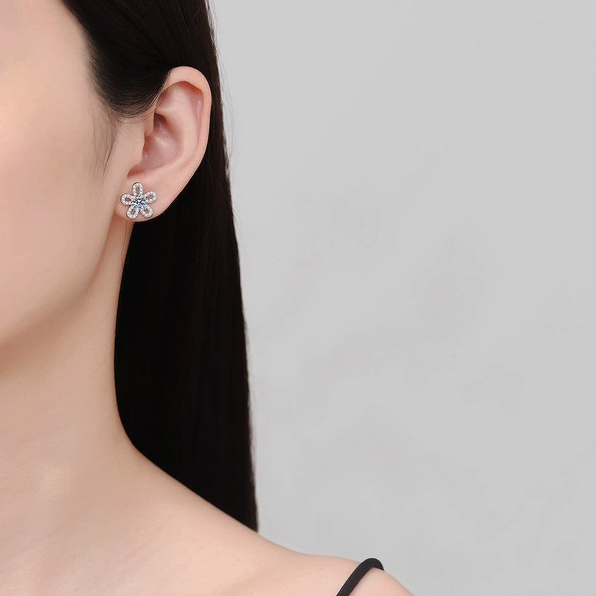 Floral Moissanite Stud Earrings with CZ in White Gold-Plated S925 Silver worn on ear by model