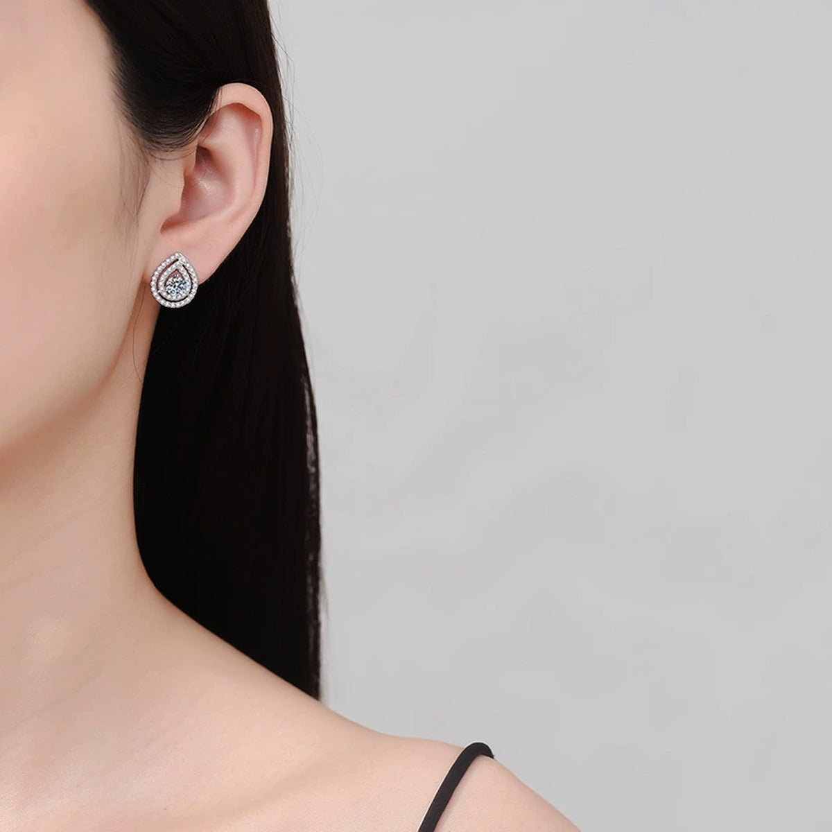 Pear Halo Moissanite Stud Earrings with CZ in White Gold-Plated S925 worn on ear by model