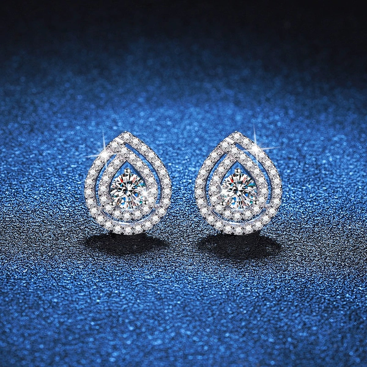 Pear Halo Moissanite Stud Earrings with CZ in White Gold-Plated S925 blue scene close-up view