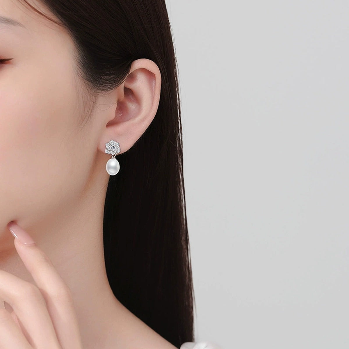 Floral Pearl Moissanite Stud Drop Earrings with CZ in White Gold-Plated S925 Sterling Silver worn on ear by model