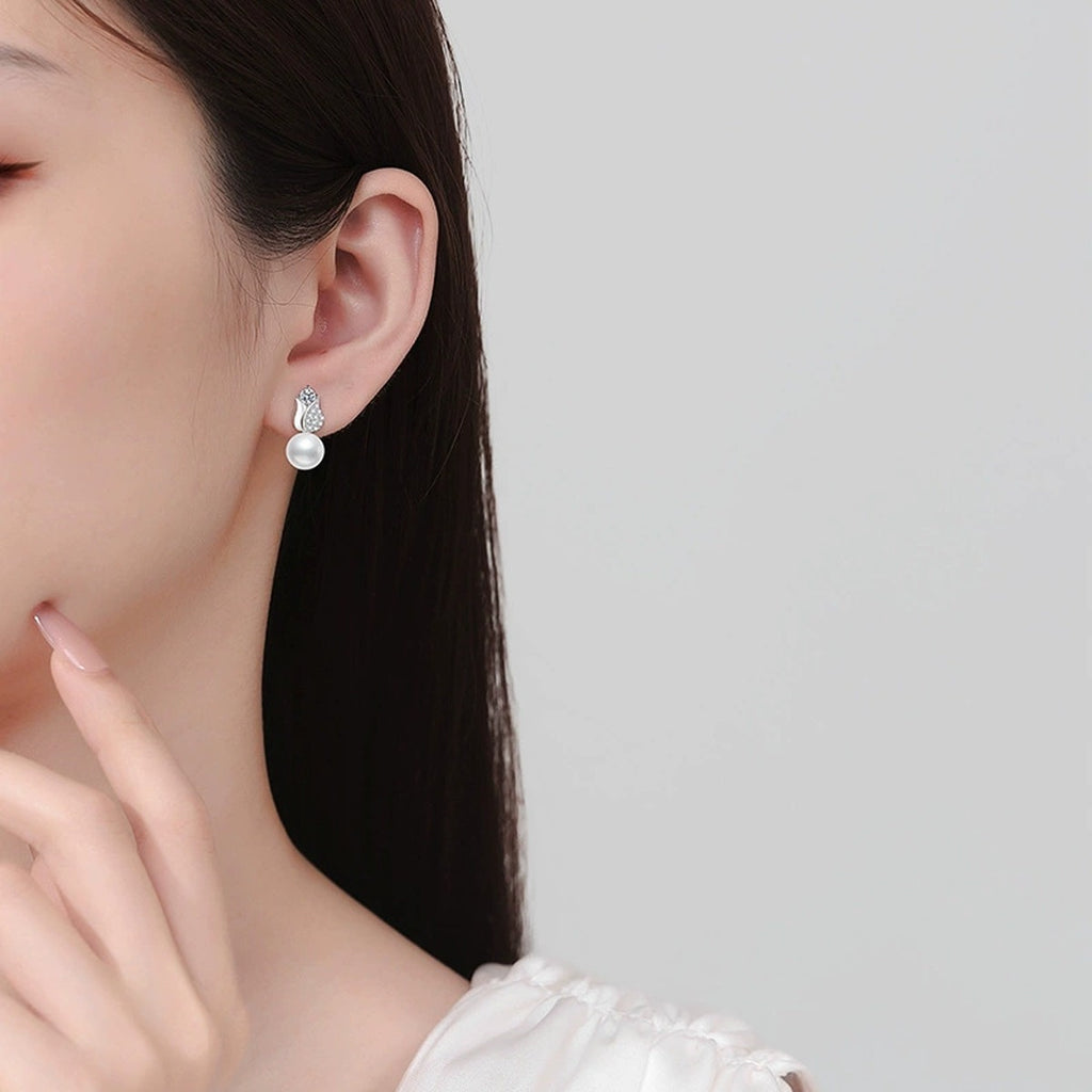 Leaf Pearl Moissanite Stud Drop Earrings with CZ in White Gold-Plated S925 Sterling Silver worn on ear by model